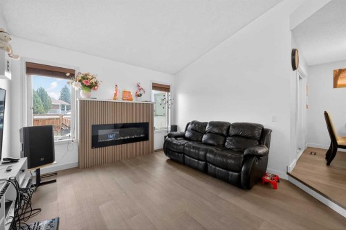35 Erin Green Place Se, Calgary, AB - Indoor Photo Showing Living Room With Fireplace