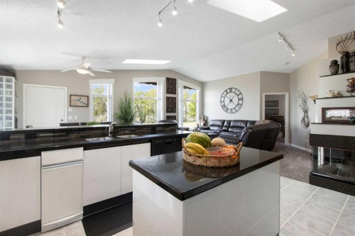 654 Lakeside Drive, Rural Vulcan County, AB - Indoor Photo Showing Kitchen With Fireplace