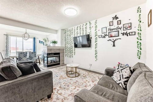58 Bridleridge Green Sw, Calgary, AB - Indoor Photo Showing Living Room With Fireplace