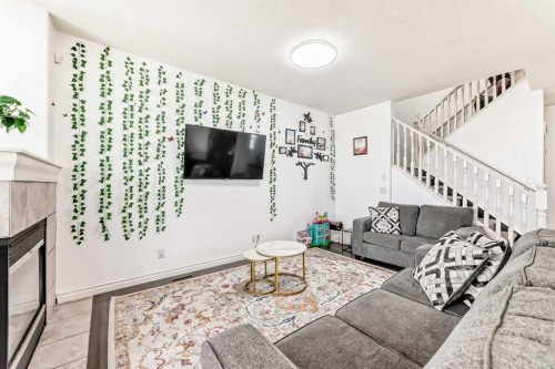 58 Bridleridge Green Sw, Calgary, AB - Indoor Photo Showing Living Room With Fireplace