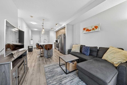 403-71 Shawnee Common Sw, Calgary, AB - Indoor Photo Showing Living Room