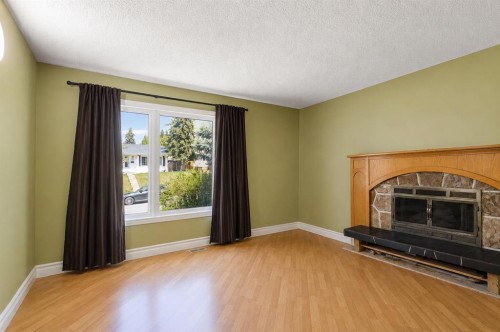 5724 Dalmead Crescent Nw, Calgary, AB - Indoor Photo Showing Living Room With Fireplace