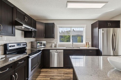 73 Marine Drive Se, Calgary, AB - Indoor Photo Showing Kitchen With Stainless Steel Kitchen With Double Sink With Upgraded Kitchen