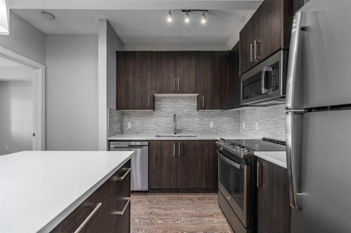 205-12 Sage Hill Terrace Nw, Calgary, AB - Indoor Photo Showing Kitchen With Stainless Steel Kitchen With Upgraded Kitchen