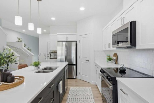 55 Heritage Manor, Cochrane, AB - Indoor Photo Showing Kitchen With Double Sink With Upgraded Kitchen