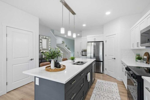 55 Heritage Manor, Cochrane, AB - Indoor Photo Showing Kitchen With Double Sink With Upgraded Kitchen