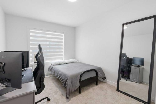 55 Heritage Manor, Cochrane, AB - Indoor Photo Showing Bedroom