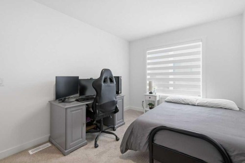 55 Heritage Manor, Cochrane, AB - Indoor Photo Showing Bedroom