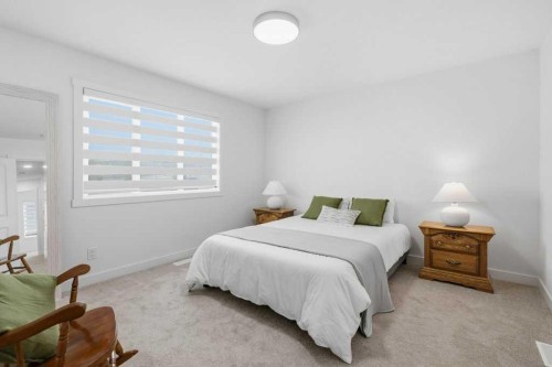 55 Heritage Manor, Cochrane, AB - Indoor Photo Showing Bedroom