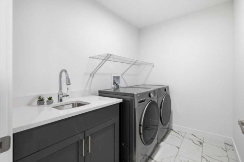 55 Heritage Manor, Cochrane, AB - Indoor Photo Showing Laundry Room