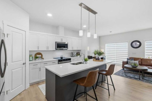 55 Heritage Manor, Cochrane, AB - Indoor Photo Showing Kitchen With Double Sink With Upgraded Kitchen