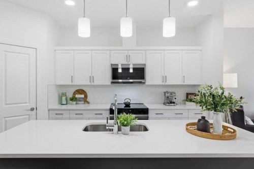 55 Heritage Manor, Cochrane, AB - Indoor Photo Showing Kitchen With Upgraded Kitchen