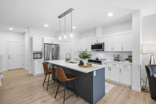 55 Heritage Manor, Cochrane, AB - Indoor Photo Showing Kitchen With Upgraded Kitchen