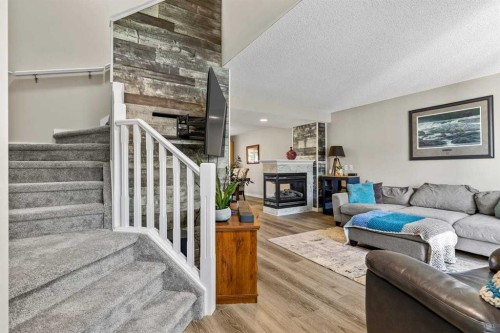 65 Prestwick Heights Se, Calgary, AB - Indoor Photo Showing Living Room With Fireplace