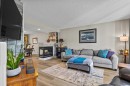 65 Prestwick Heights Se, Calgary, AB  - Indoor Photo Showing Living Room With Fireplace 