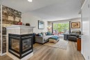 65 Prestwick Heights Se, Calgary, AB  - Indoor Photo Showing Living Room With Fireplace 