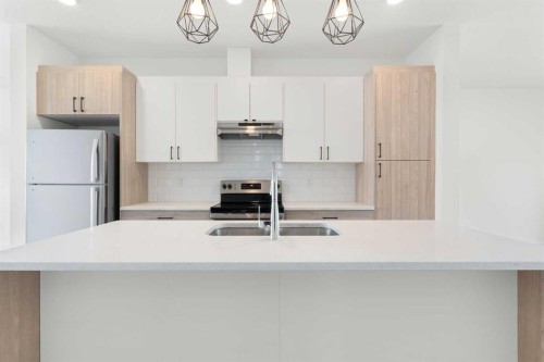 1701-24 Rivercrest Drive, Cochrane, AB - Indoor Photo Showing Kitchen With Stainless Steel Kitchen With Double Sink With Upgraded Kitchen