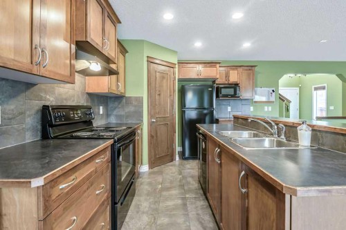 158 New Brighton Lane Se, Calgary, AB - Indoor Photo Showing Kitchen With Double Sink
