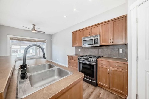 32 Copperleaf Way Se, Calgary, AB - Indoor Photo Showing Kitchen With Double Sink