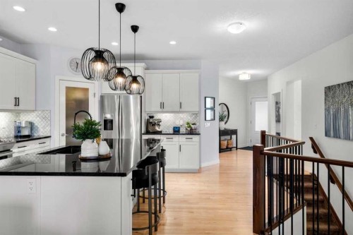 25 Fireside Landing, Cochrane, AB - Indoor Photo Showing Kitchen With Upgraded Kitchen