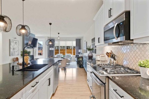 25 Fireside Landing, Cochrane, AB - Indoor Photo Showing Kitchen With Double Sink With Upgraded Kitchen