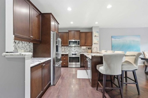 16 Sunset Terrace, Cochrane, AB - Indoor Photo Showing Kitchen With Stainless Steel Kitchen With Upgraded Kitchen