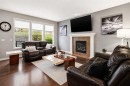 16 Sunset Terrace, Cochrane, AB  - Indoor Photo Showing Living Room With Fireplace 