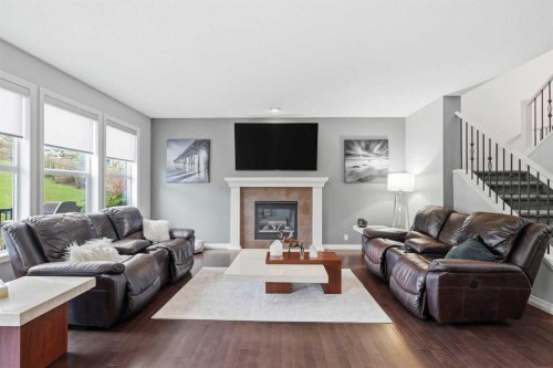16 Sunset Terrace, Cochrane, AB - Indoor Photo Showing Living Room With Fireplace
