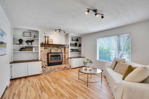 62 Macewan Park View Nw, Calgary, AB - Indoor Photo Showing Living Room With Fireplace