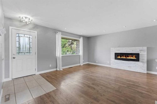 819 Avonlea Place Se, Calgary, AB - Indoor Photo Showing Living Room With Fireplace