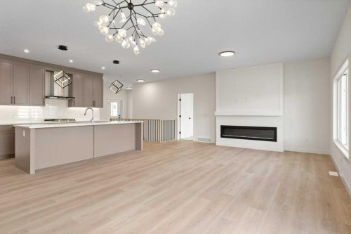 206 Monterey Bay Se, High River, AB - Indoor Photo Showing Kitchen With Fireplace