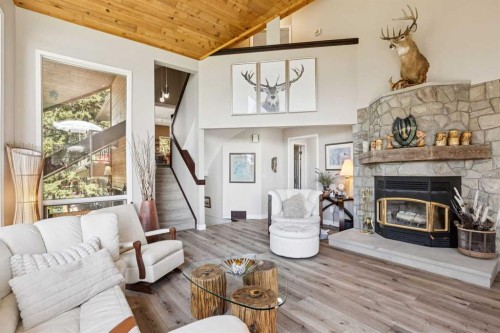 36 Cummer Place, Bragg Creek, AB - Indoor Photo Showing Living Room With Fireplace