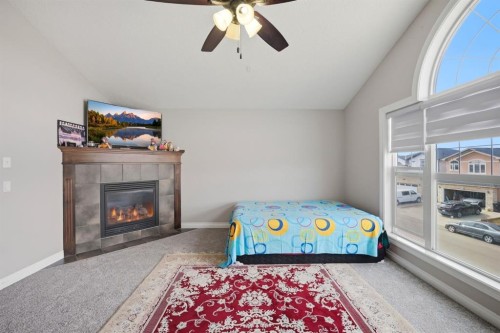 591 Taralake Way Ne, Calgary, AB - Indoor Photo Showing Bedroom With Fireplace