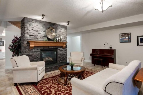 100-274256 272 Street West, Rural Foothills County, AB - Indoor Photo Showing Living Room With Fireplace