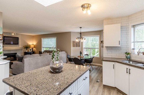 79 West Lakeview Passage, Chestermere, AB - Indoor Photo Showing Kitchen With Fireplace