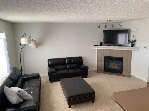 799 Tuscany Drive Nw, Calgary, AB - Indoor Photo Showing Living Room With Fireplace