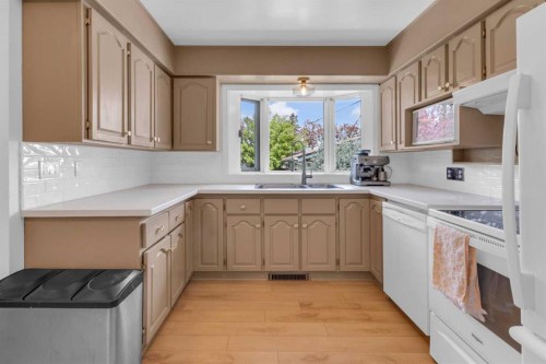 77 Hogarth Crescent Sw, Calgary, AB - Indoor Photo Showing Kitchen With Double Sink