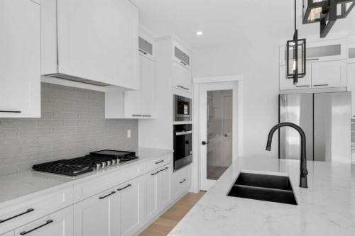 14 Ranchers Meadows, Okotoks, AB - Indoor Photo Showing Kitchen With Double Sink With Upgraded Kitchen