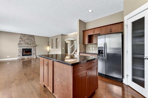 337 Discovery Ridge Boulevard Sw, Calgary, AB - Indoor Photo Showing Kitchen With Fireplace With Stainless Steel Kitchen