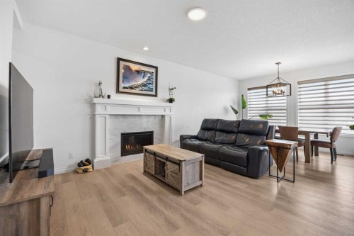 224 Precedence Hill, Cochrane, AB - Indoor Photo Showing Living Room With Fireplace