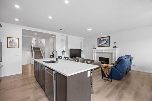 224 Precedence Hill, Cochrane, AB - Indoor Photo Showing Kitchen With Fireplace