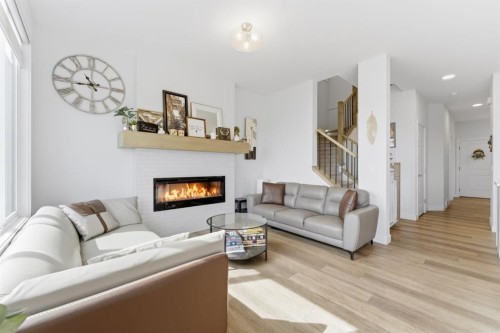 936 Langholm Drive Se, Airdrie, AB - Indoor Photo Showing Living Room With Fireplace