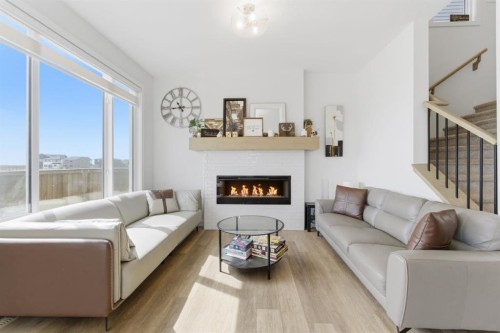 936 Langholm Drive Se, Airdrie, AB - Indoor Photo Showing Living Room With Fireplace