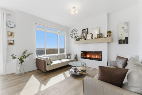 936 Langholm Drive Se, Airdrie, AB - Indoor Photo Showing Living Room With Fireplace
