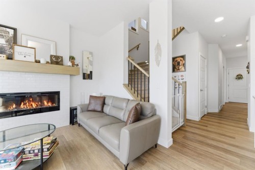 936 Langholm Drive Se, Airdrie, AB - Indoor Photo Showing Living Room With Fireplace
