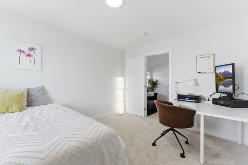 936 Langholm Drive Se, Airdrie, AB - Indoor Photo Showing Bedroom