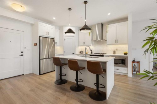 205-10 Sage Hill Walk Nw, Calgary, AB - Indoor Photo Showing Kitchen With Stainless Steel Kitchen With Upgraded Kitchen