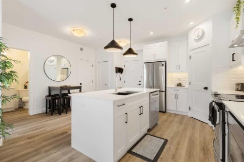 205-10 Sage Hill Walk Nw, Calgary, AB - Indoor Photo Showing Kitchen With Stainless Steel Kitchen With Upgraded Kitchen