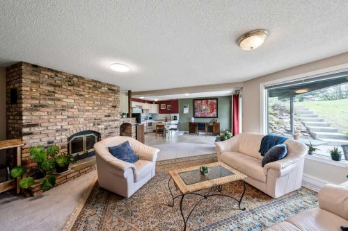 251018 Tower Ridge Estates, Rural Rocky View County, AB - Indoor Photo Showing Living Room With Fireplace