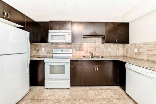303-250 Sage Valley Road Nw, Calgary, AB - Indoor Photo Showing Kitchen With Double Sink